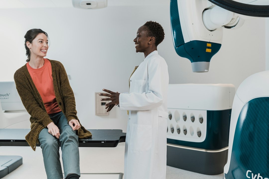 Medical professional discusses with patient in a clinic.